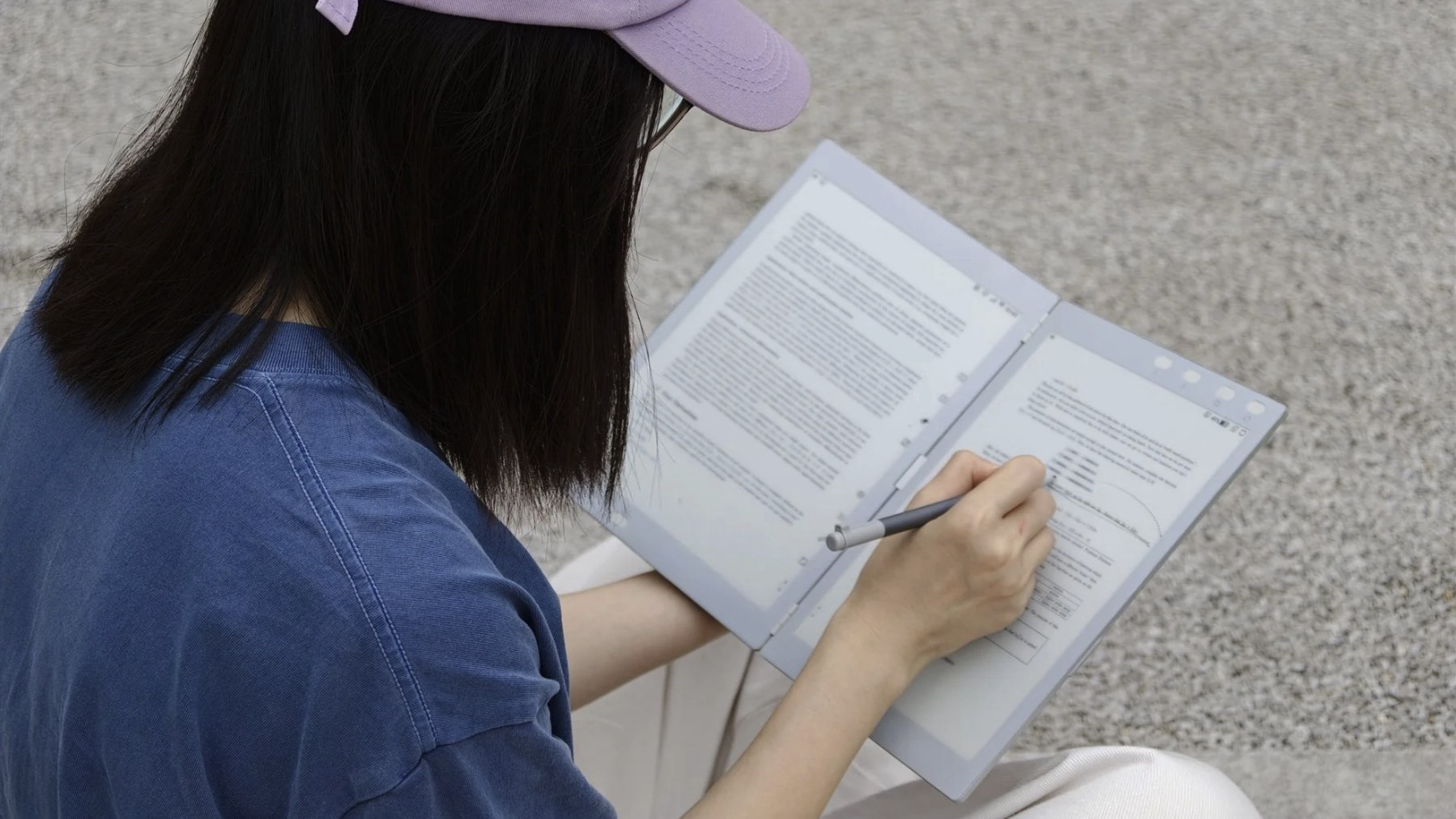 A woman taking notes on the InkLeaf